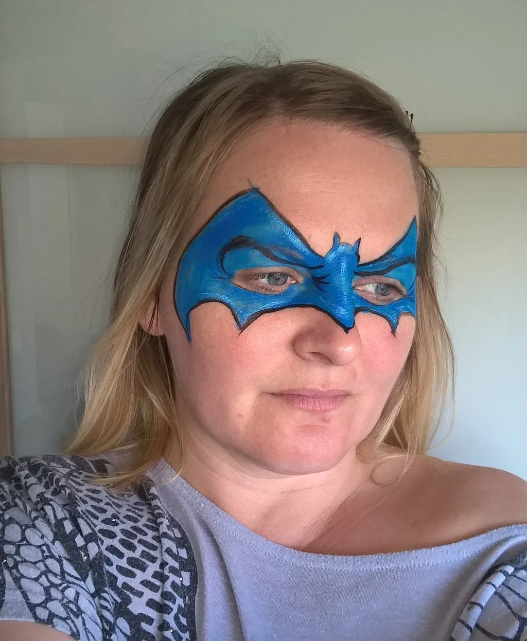 A blue bat mask face design
