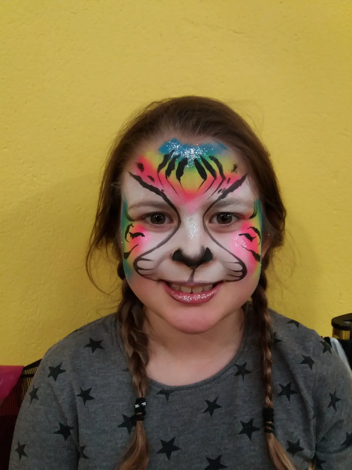 A colourful rainbow tiger face on a bright background
