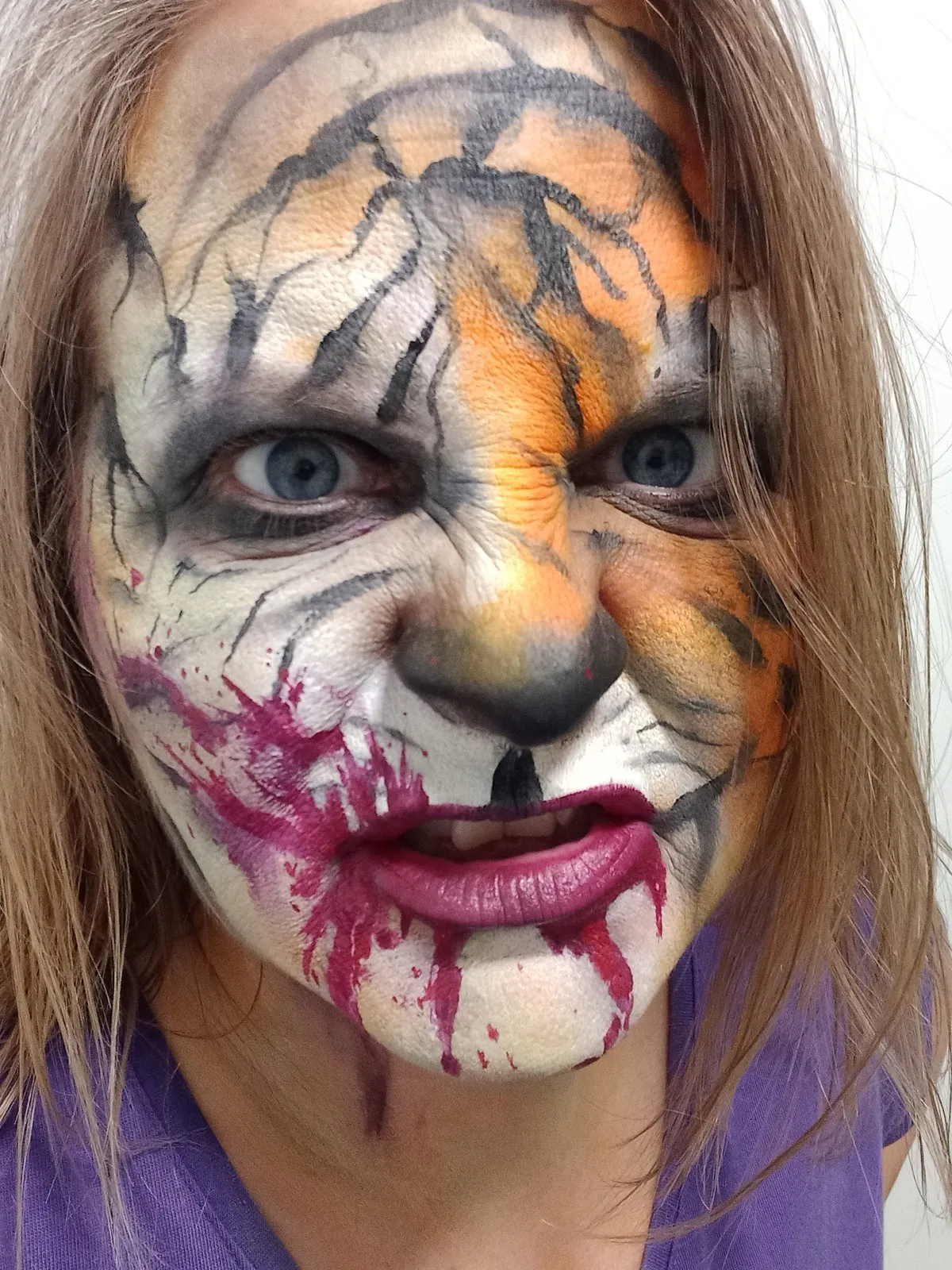 A cracked scarecrow horror face in orange tones