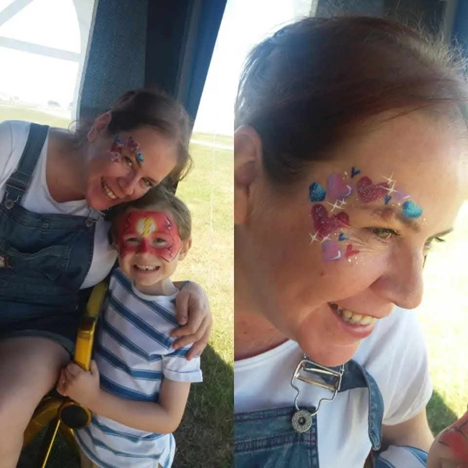 Glittery butterfly designs on a mum and child at an event