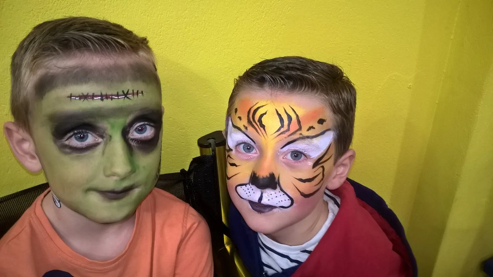 Two boys painted as Frankenstein and a tiger
