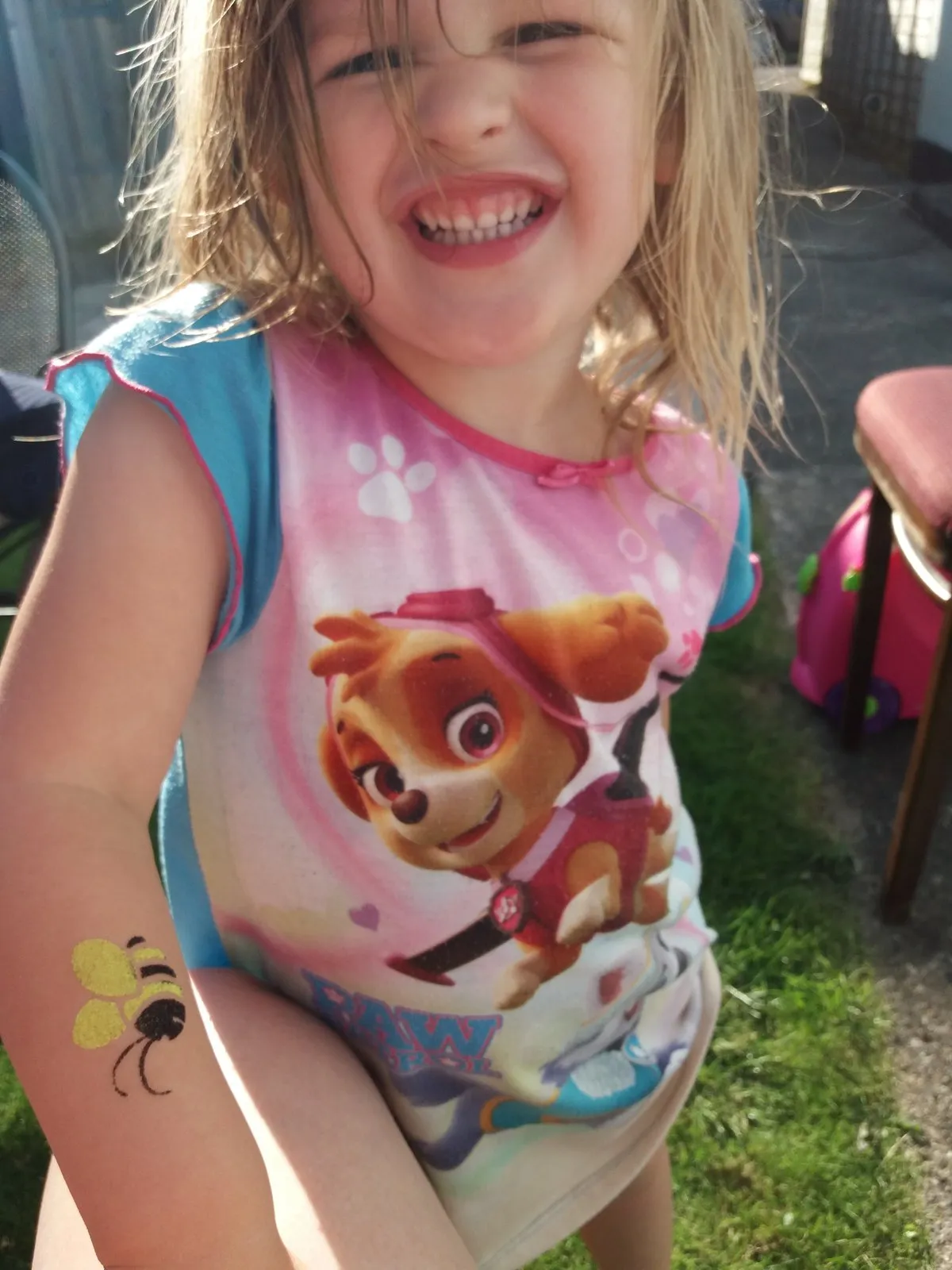 Colourful glitter body art on a child's arm