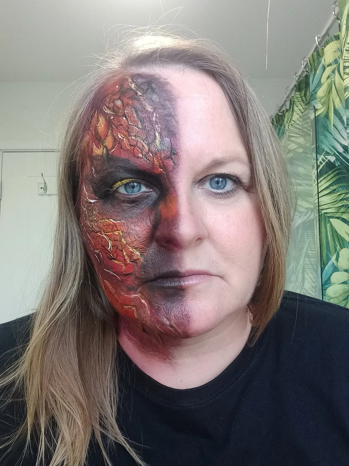 A dark rust-red half-face horror design