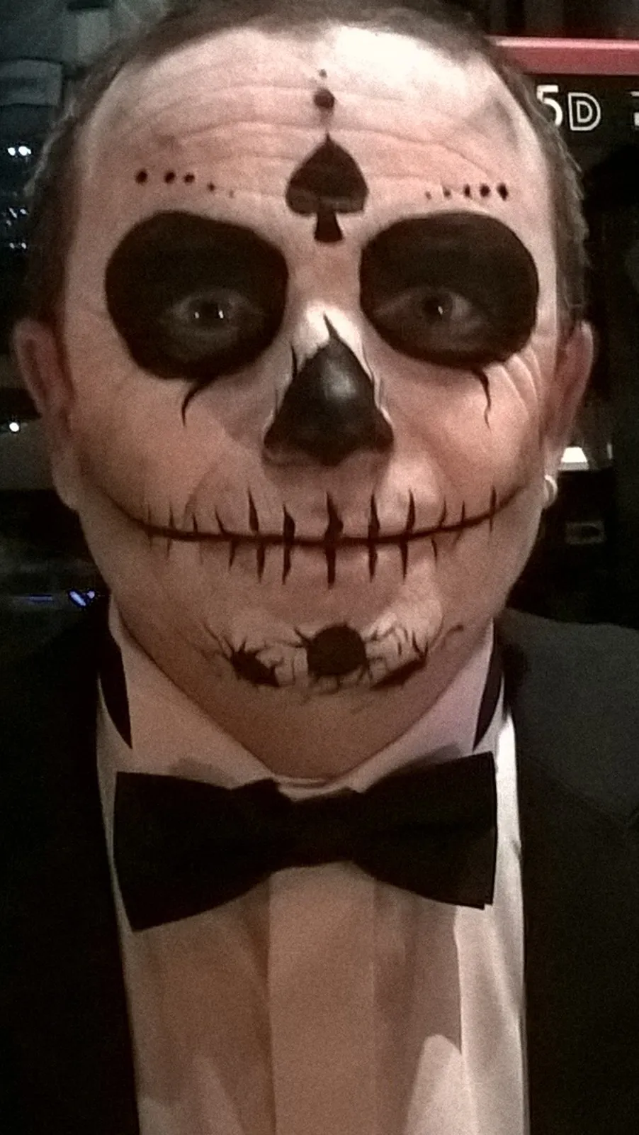 A man painted as a Day of the Dead sugar skull