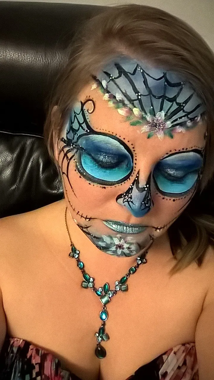 An intricate blue sugar skull face paint