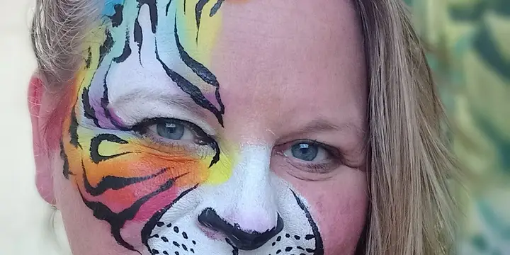 Christine wearing her own vivid rainbow tiger half-face design