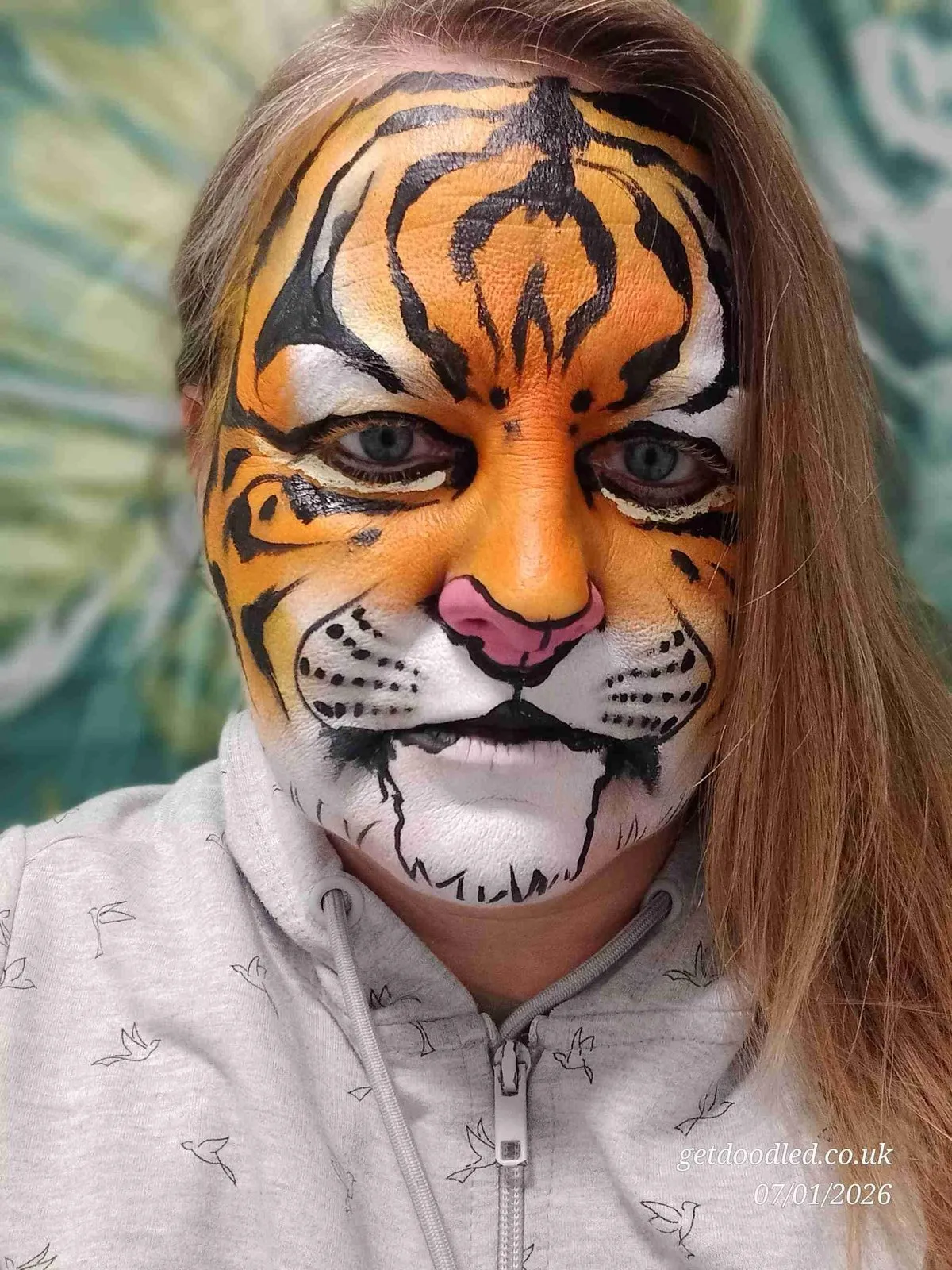 A child painted as a classic orange and black tiger