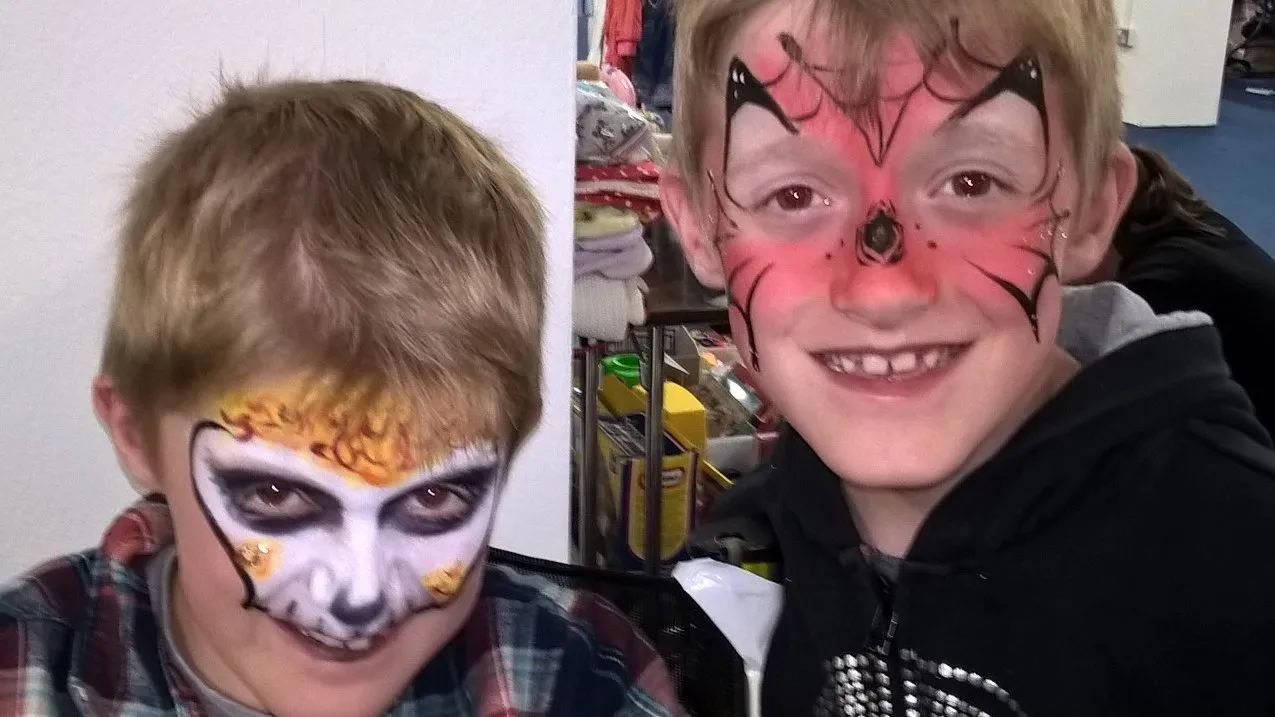 Two boys with skull and superhero face paint